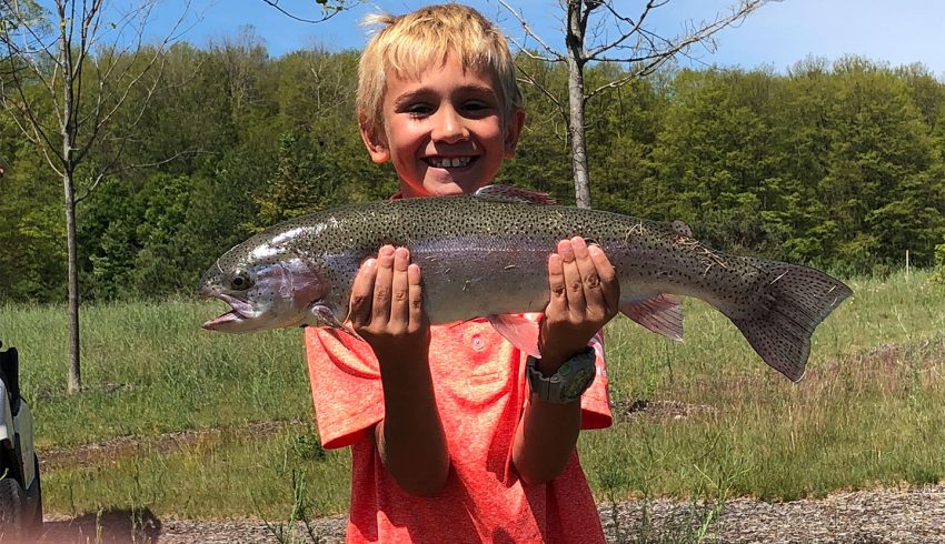 boy holding trout